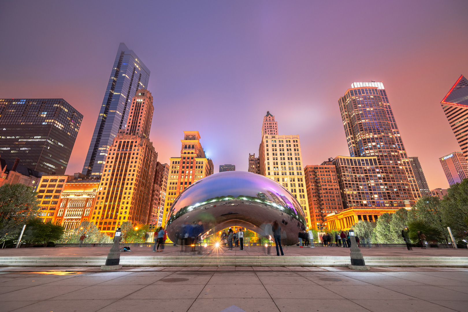 CHICAGO - ILLINOIS: MAY 12, 2018: Tourists visit Cloud Gate in Millennium Park in the evening.