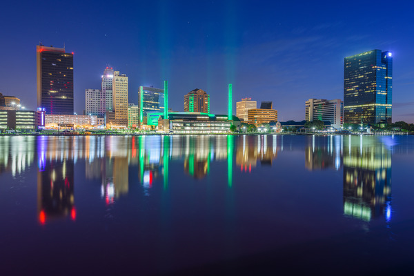 Toledo, Ohio, USA downtown skyline on the Maumee River at twilight.